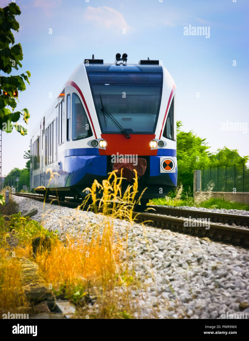 Low angle view of a commuter train in the countryside, Udine, Friuli, Italy Udine, Friuli, Italy Stock Photo