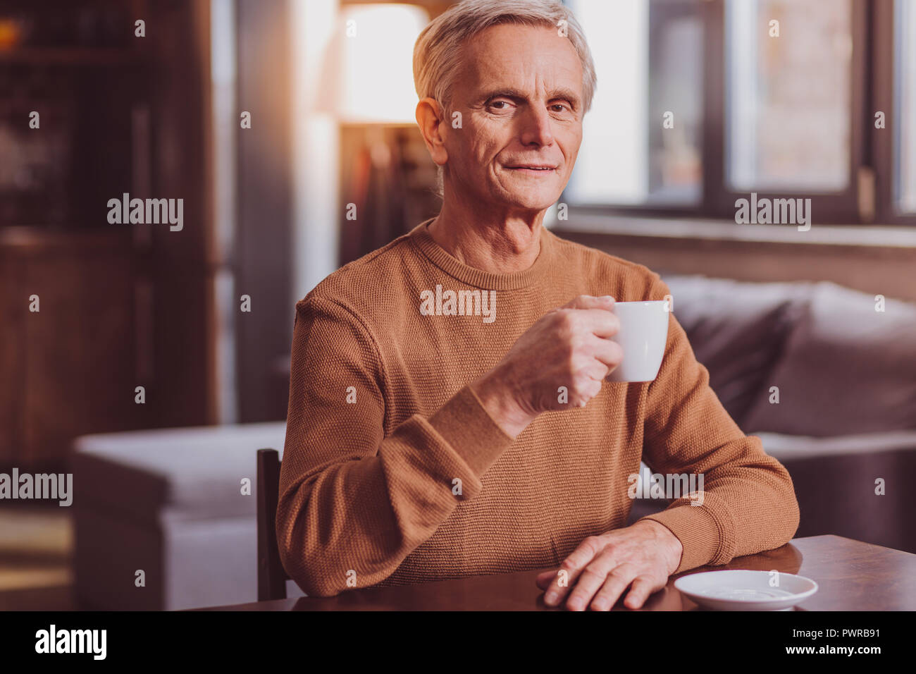 Smiling man having tea an relaxing Stock Photo