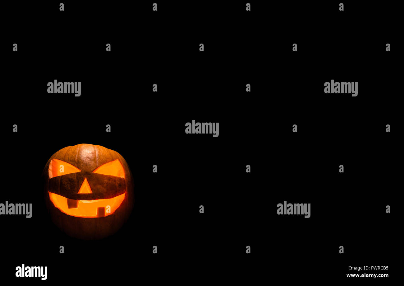 Halloween Pumpkin Lantern with Black Background Standing in the Third Rule position. Stock Photo