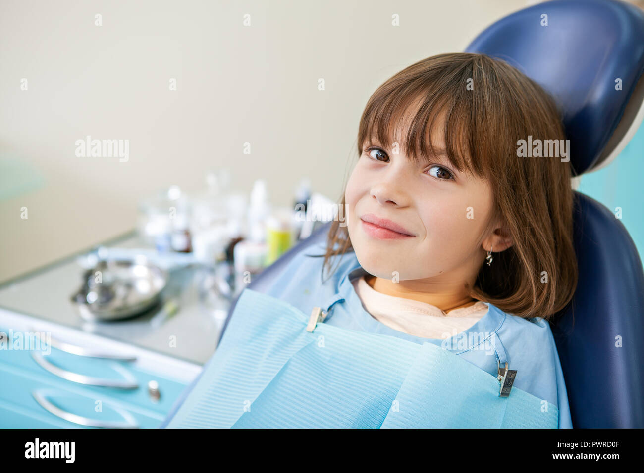Patient girl is waiting for an examination on the dental chair Stock Photo