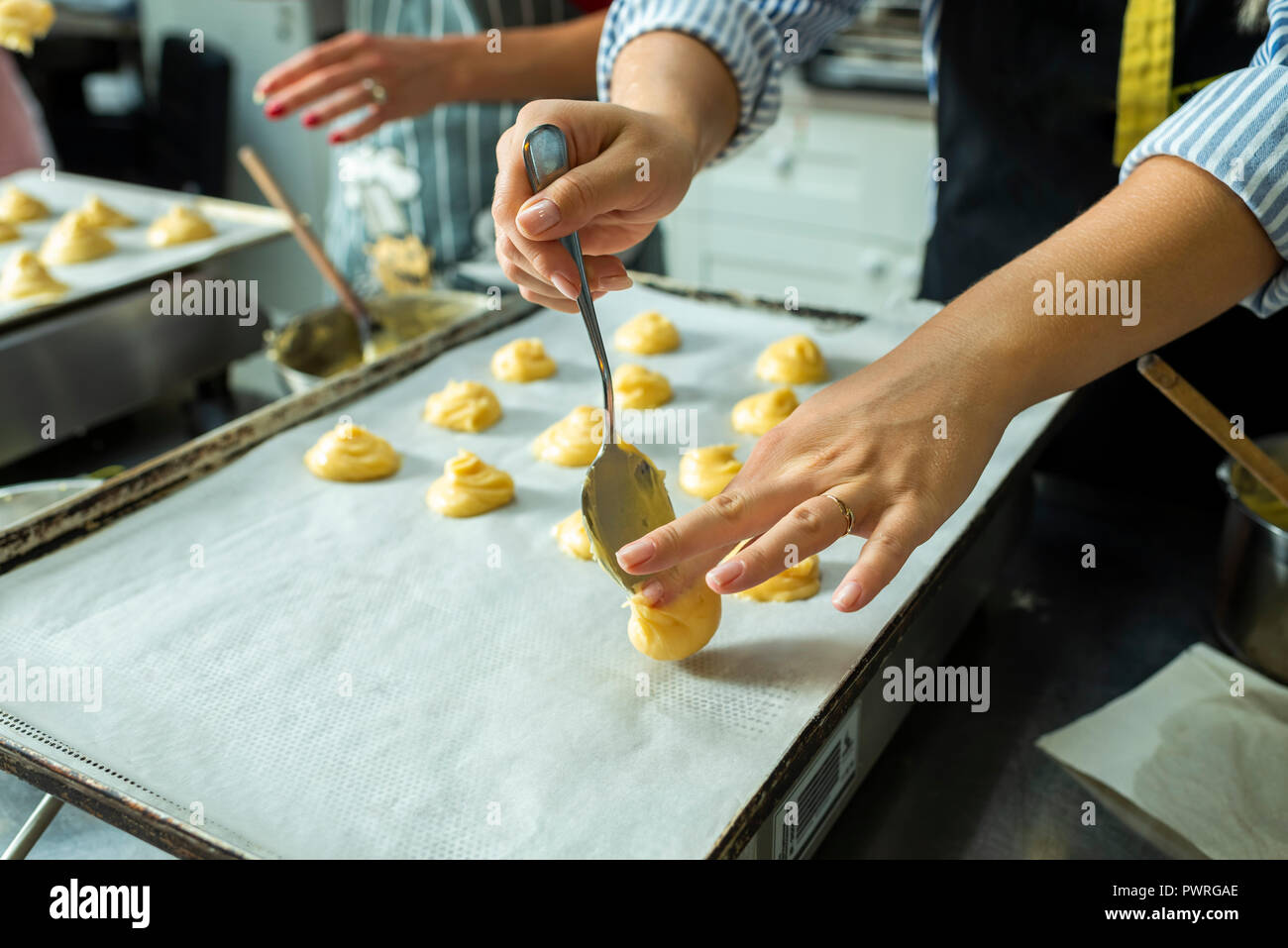 putting a puff pastry on a cake baking tray Stock Photo Alamy
