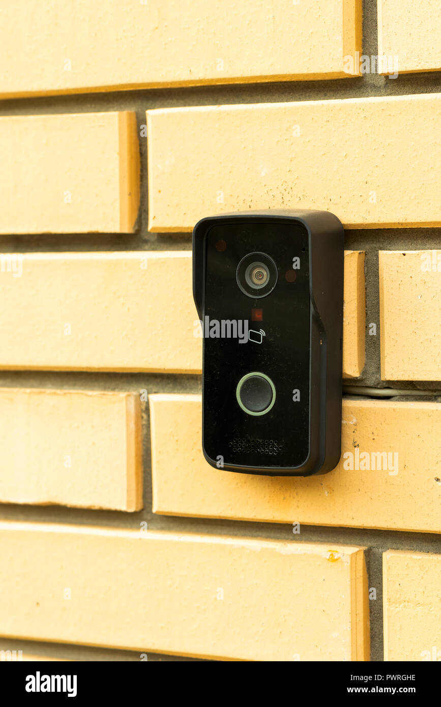 bell with a video camera on a brick wall Stock Photo