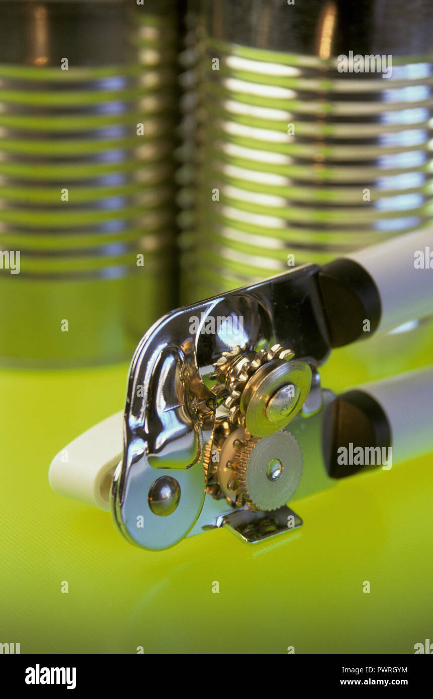 Close up of manual can opener with generic cans, USA