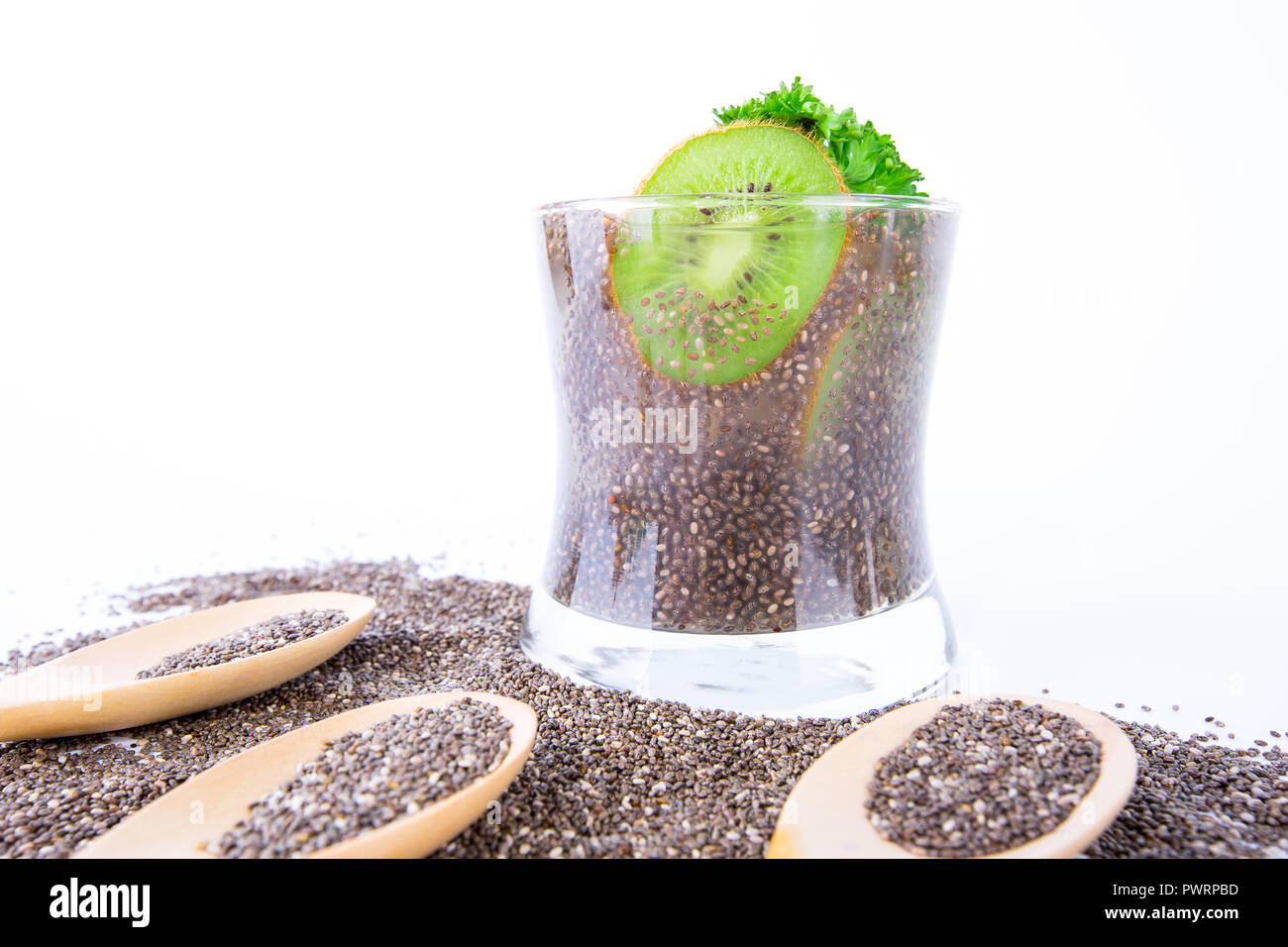healthy drink in glass with chia seeds, kiwi and lemon juice on white