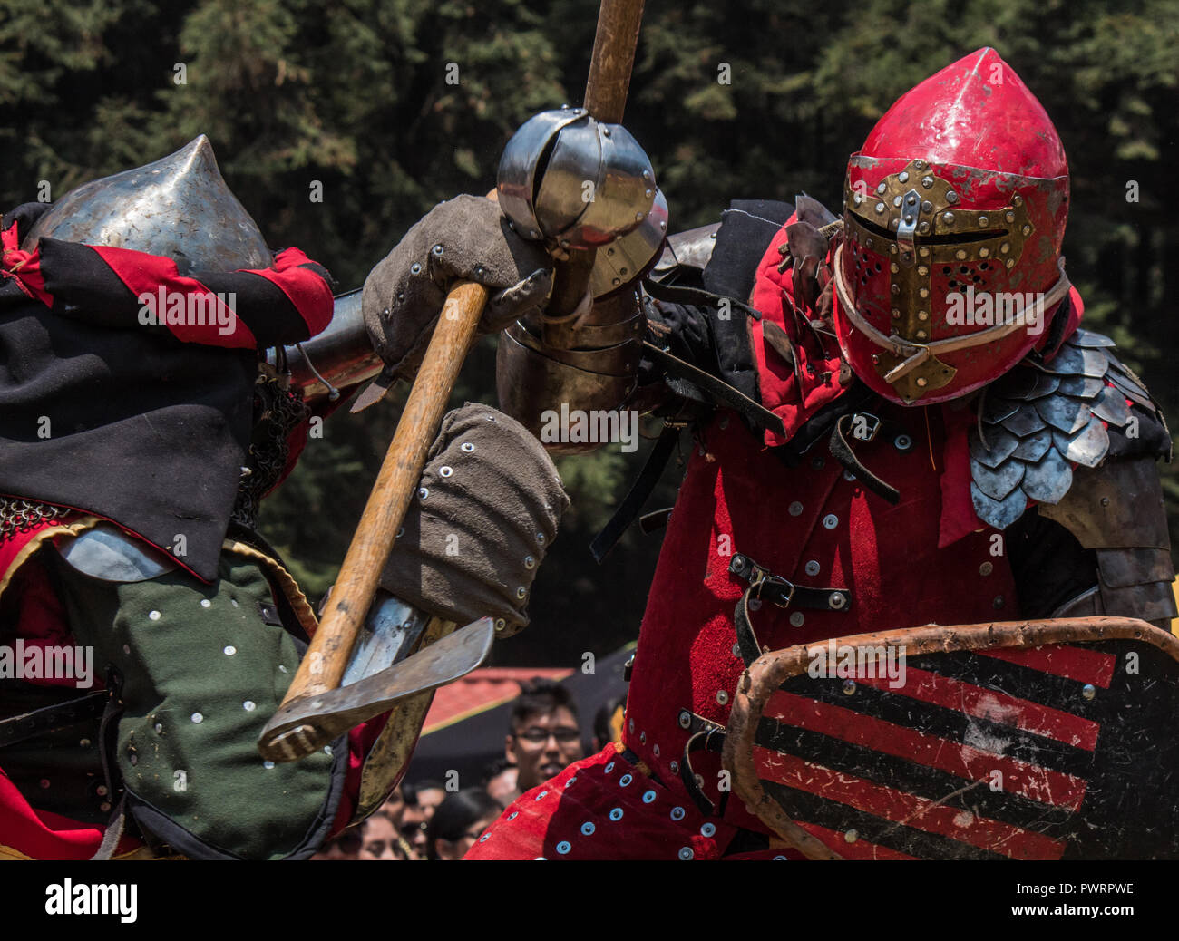 Medieval knights fighting with armor, swords and shields in festival