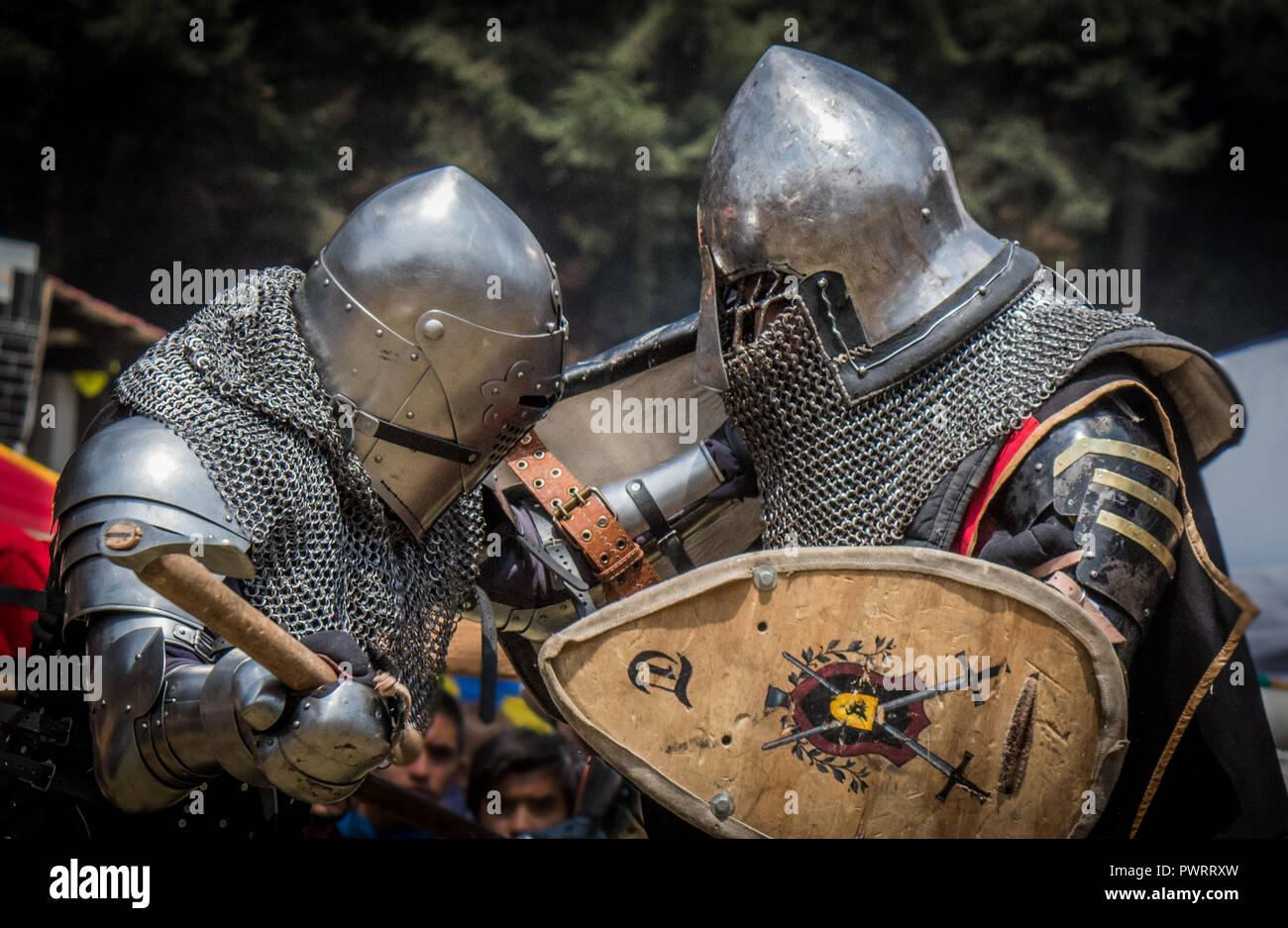 Medieval knights fighting with armor, swords and shields in festival