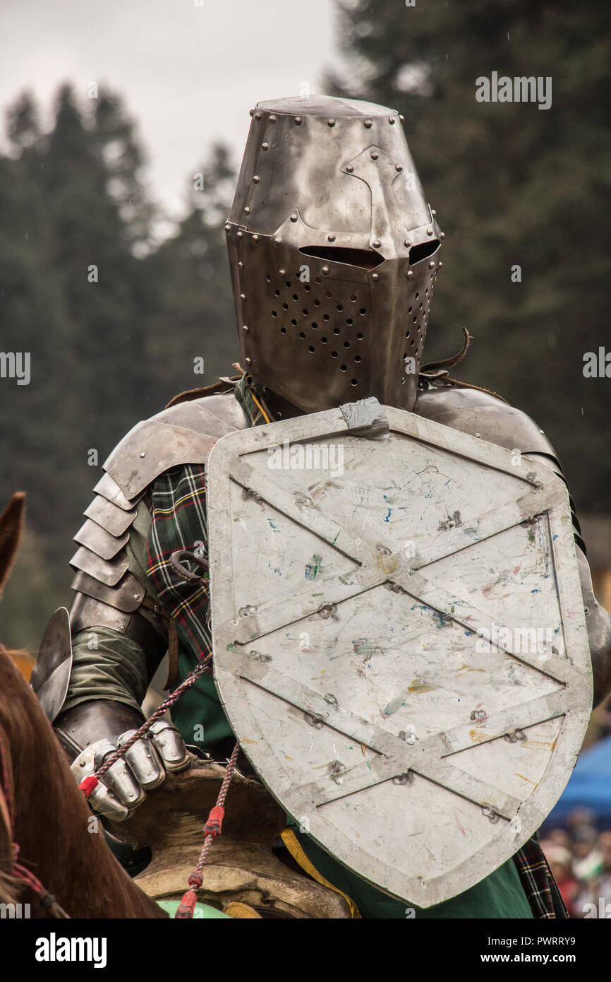 Medieval knights fighting with armor, swords and shields in festival