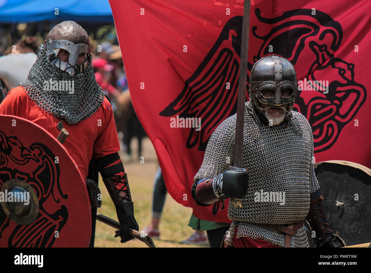 Medieval knights fighting with armor, swords and shields in festival