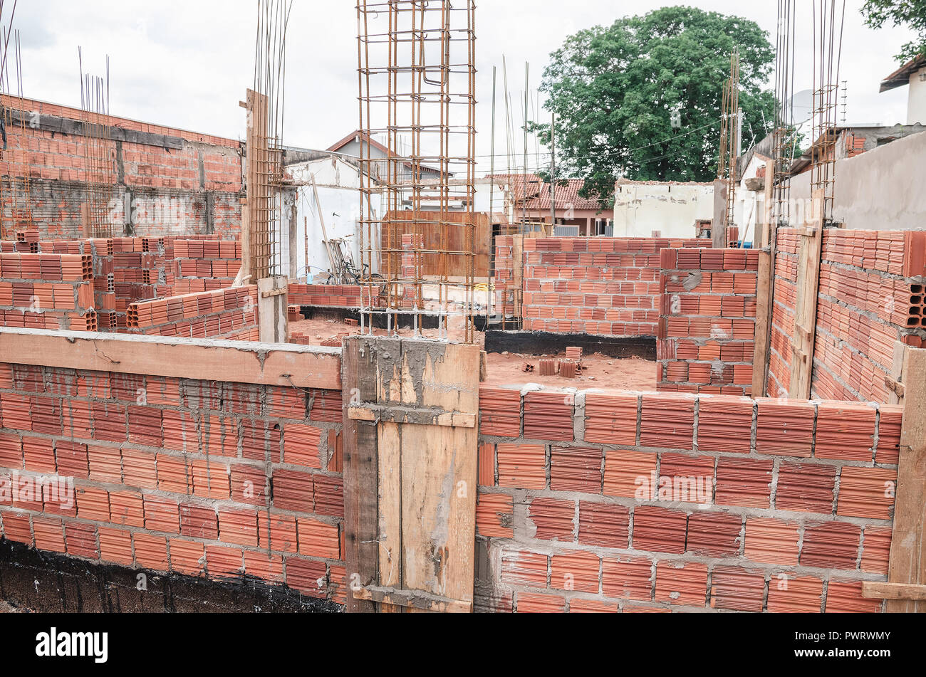Construction, land under construction of a masonry house. Structure of reinforced concrete. House made of bricks, steel rebars and concrete. Structura Stock Photo