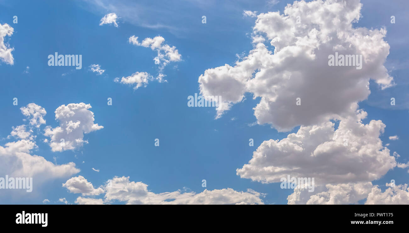 Brilliant blue sky with white puffy clouds Stock Photo