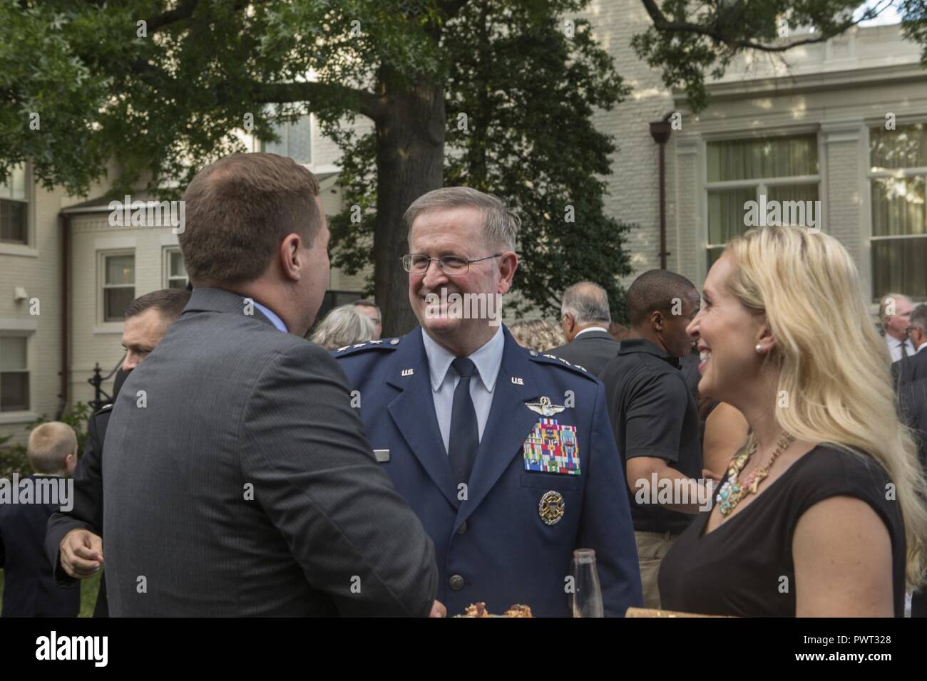 U.S. Air Force Lt. Gen. Thomas J. Trask, vice commander of Headquarters U.S. Special Operations Command (SOCOM), speaks with guests during a reception before an evening parade at Marine Barracks Washington, Washington, D.C., June 23, 2017. Evening parades are held as a means of honoring senior officials, distinguished citizens and supporters of the Marine Corps. Stock Photo