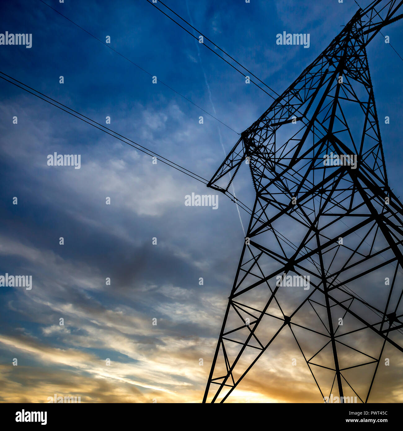Electricity tower beneath a dark cloudy sky Stock Photo - Alamy