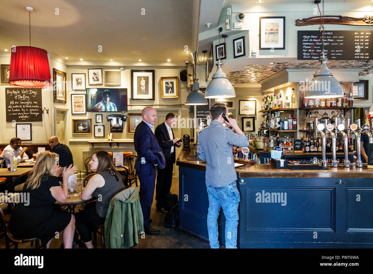 London England,UK,Southwark,Blackfriars Rd,The Ring,historic bar public house pub,interior inside,barstool,drinking,beer,man men male,woman female wom Stock Photo