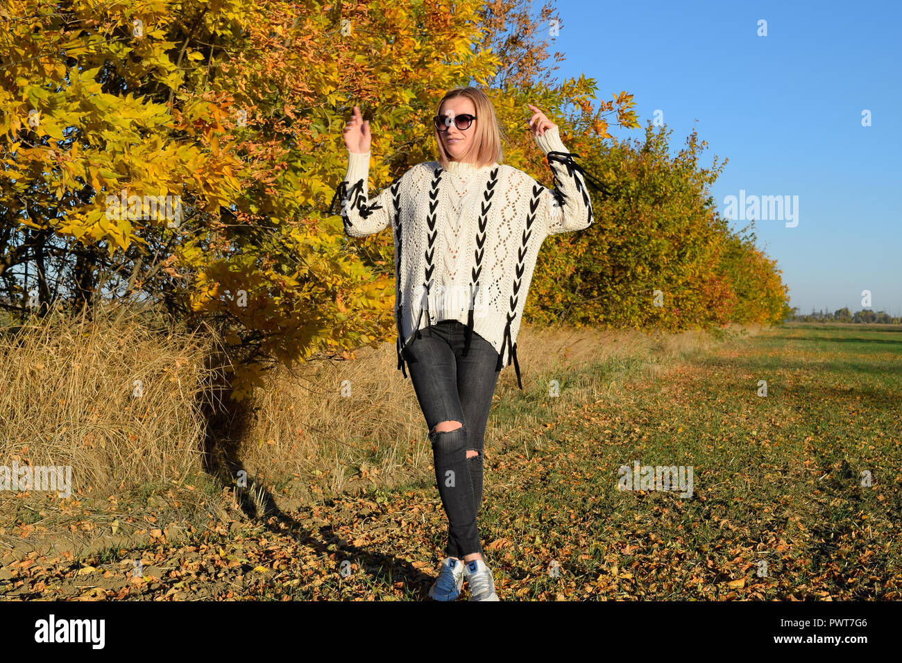 Girl on a background of yellow leaves of autumn trees. Girl in ...