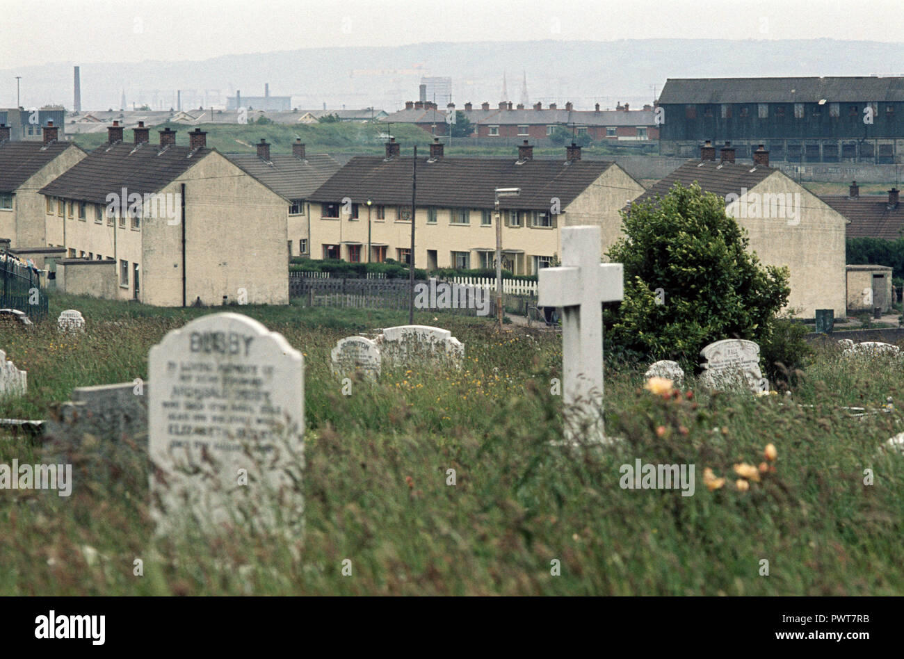 Cemetry and dumping ground in Ballymurphy mainly nationalist estate for hijacked burnt vehicles and buses, West Belfast, Northern Ireland, during The Troubles, 1970s Stock Photo