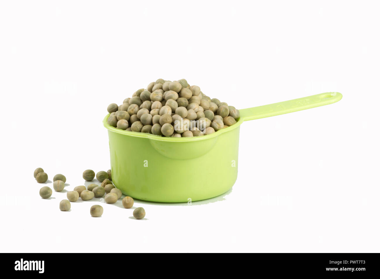 measuring cup with dehydrated peas on white background Stock Photo