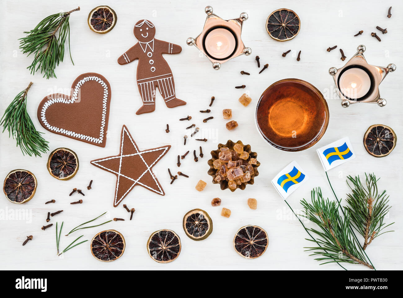 Swedish Christmas decor with flags, candles, teacup, ginger biscuits