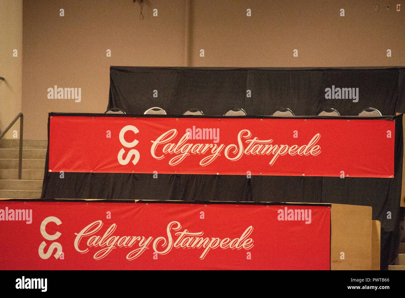 Calgary Stampede banners drape the table fronts in the stands at the
