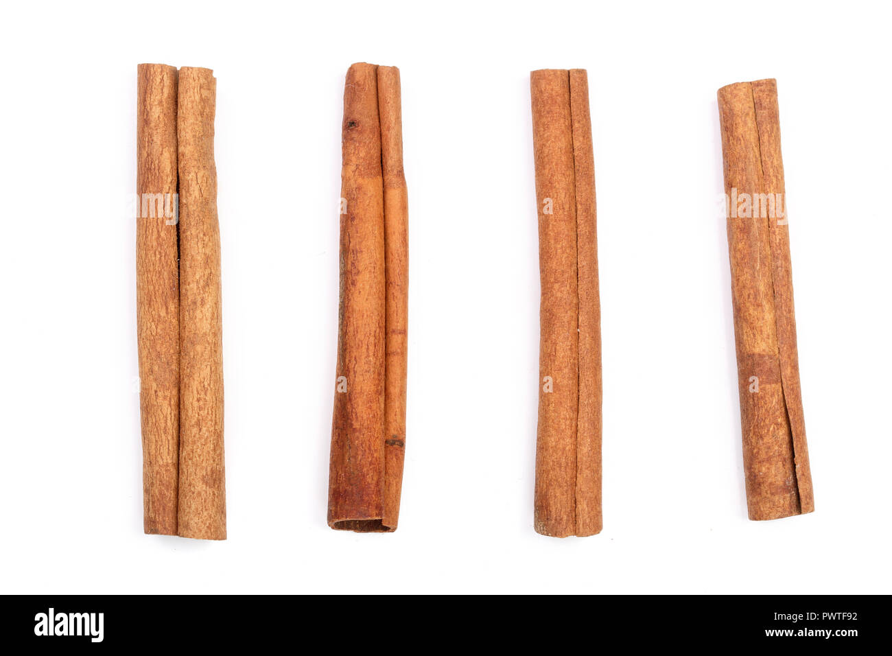 Cinnamon sticks isolated on white background. Top view. Stock Photo