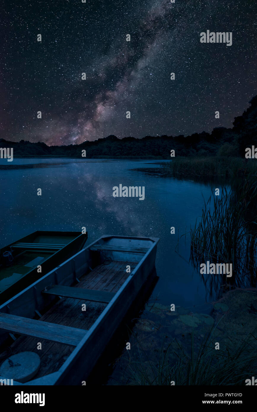 Stunning vibrant Milky Way composite image over landscape of lake with ...