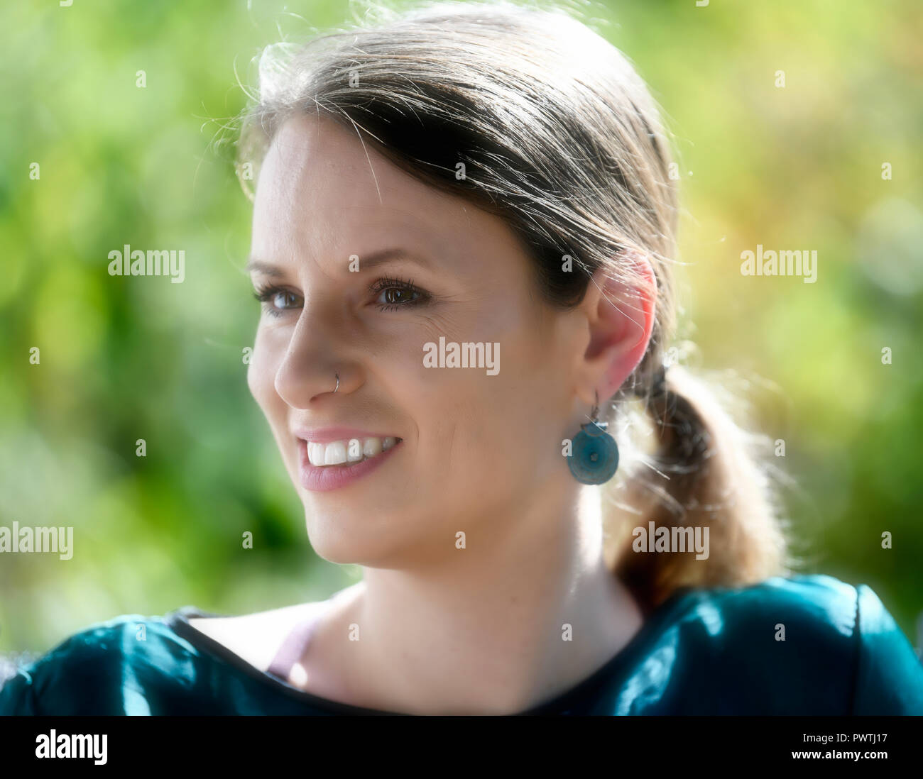 Young woman smiles, portrait, Germany Stock Photo