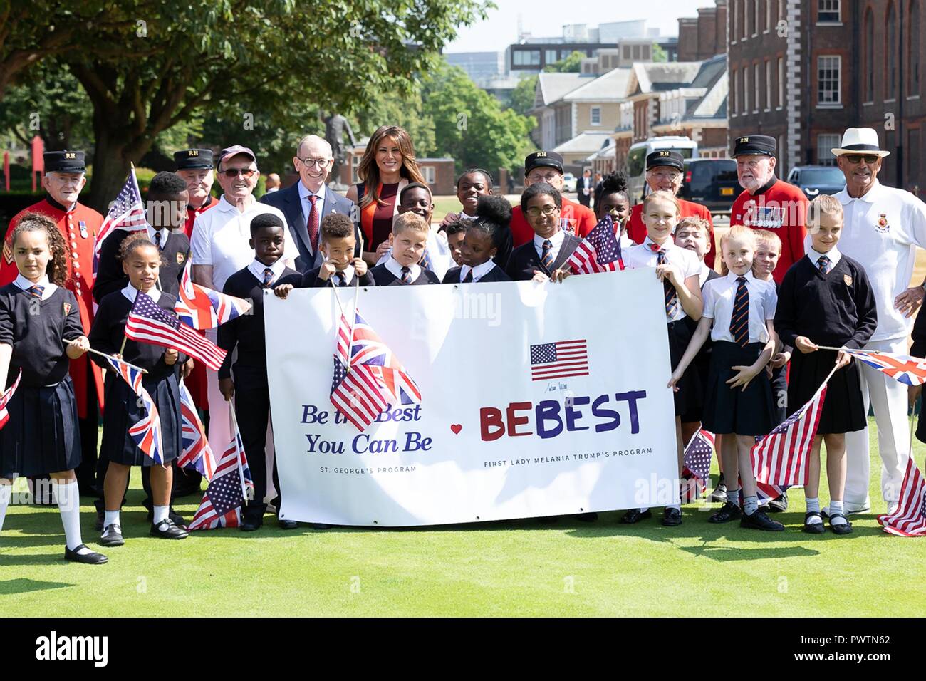 U.S First Lady Melania Trump and Philip May, husband of British Prime Minister Theresa May, hold flags and the BeBest Banner during a visit to the Royal Hospital Chelsea July 13, 2018 in London, United Kingdom. Stock Photo