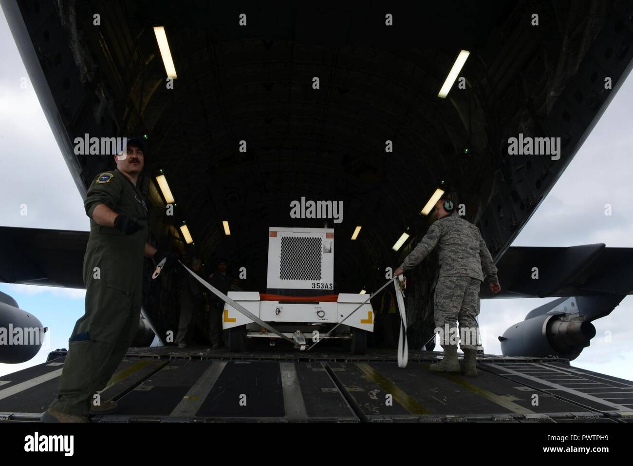 Tech. Sgt. Tom Hough (left), a loadmaster assigned to the 249th Airlift
