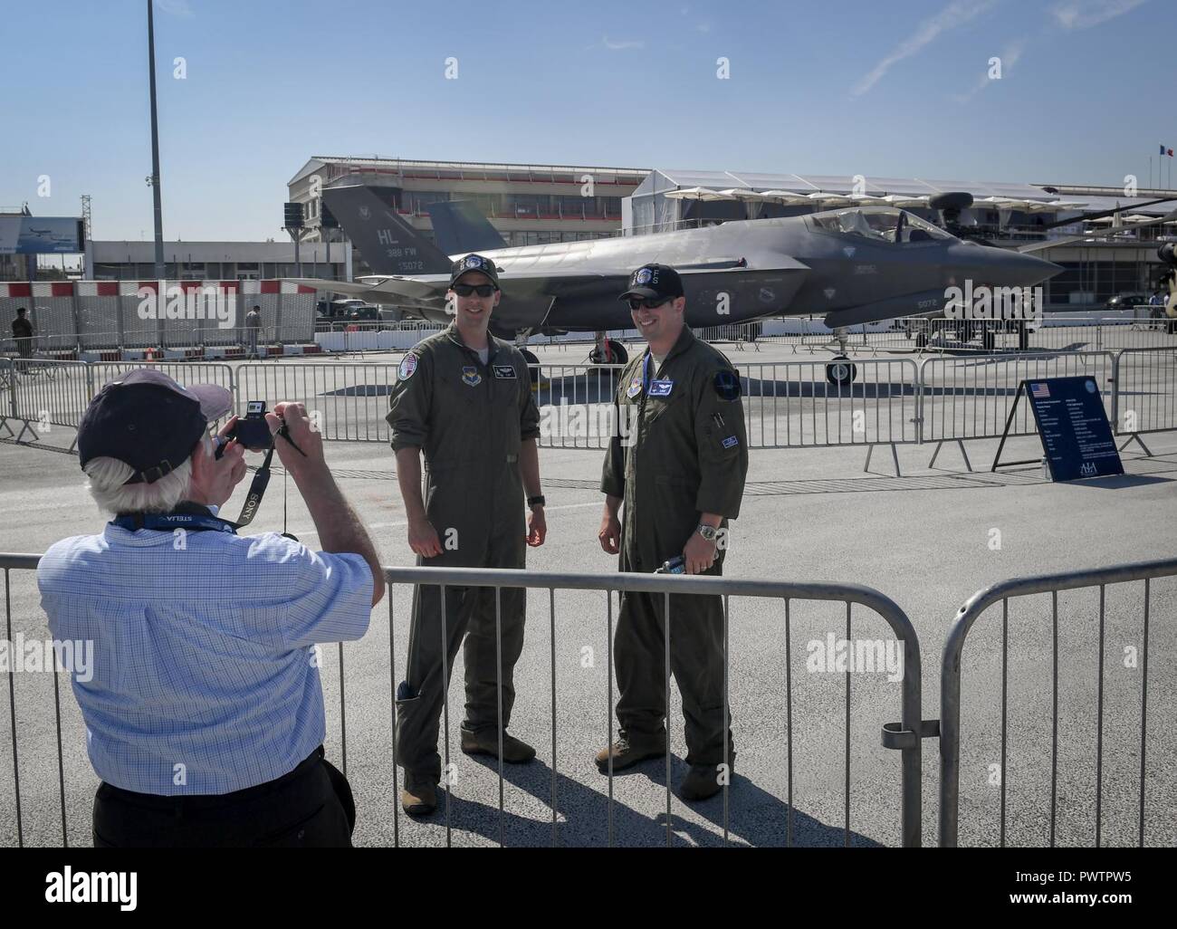 F-35A Lighting II pilots from Hill Air Force Base, Utah, pose for a photo in the U.S. corral at the Paris Air Show June 20, 2017 at Le Bourget, France. Aside from the F-35, the U.S. is displaying an F-16 Fighting Falcon, a CH-47 Chinook, an AH-64 Apache, a P-8 Poseidon, a C-130J Super Hercules and a CV-22 Osprey. The Paris Air Show offers the U.S. a unique opportunity to display their leadership in aerospeace and technology on an international scale. Stock Photo