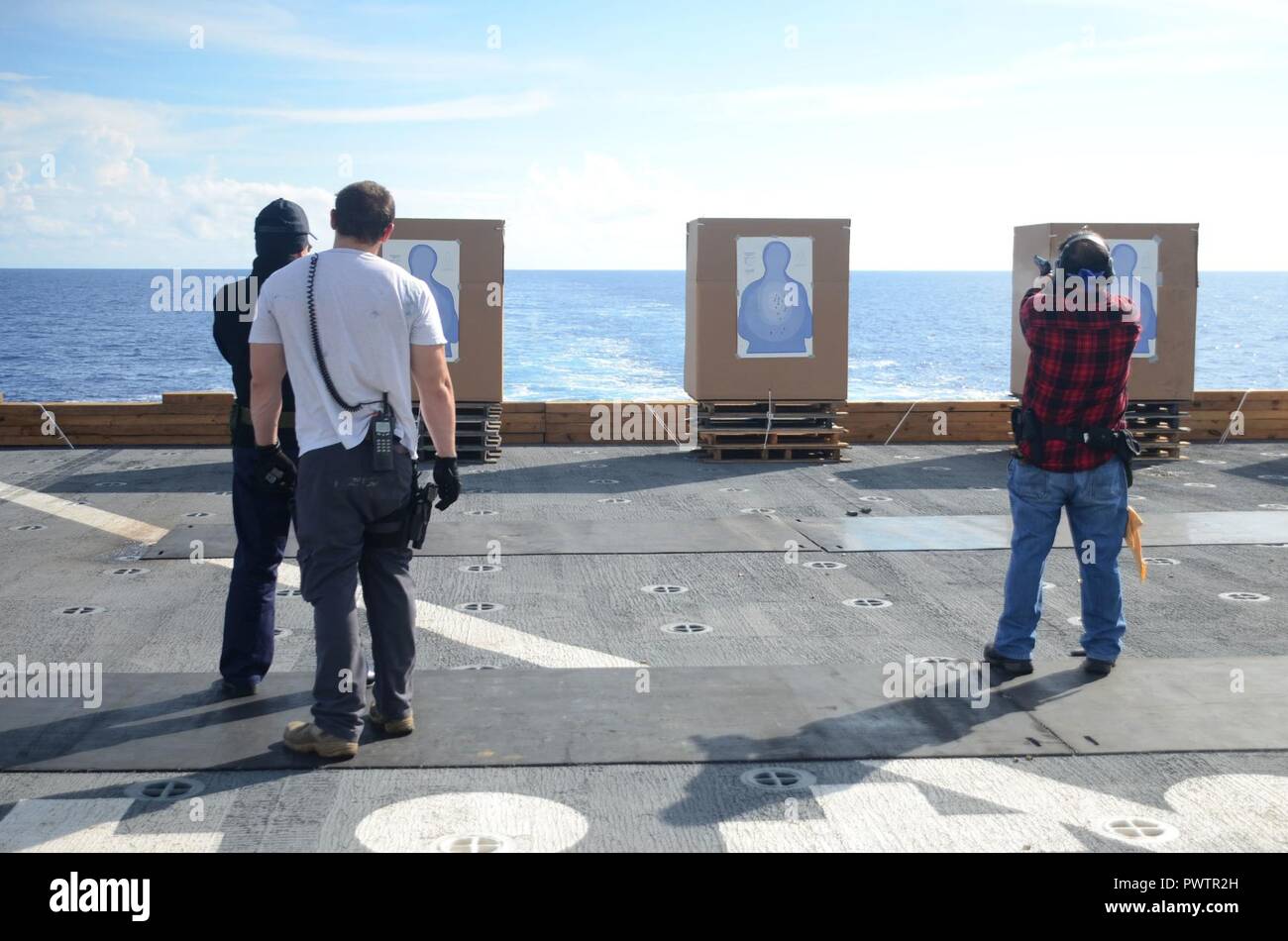 PACIFIC OCEAN (June 21, 2017) Civilian Mariners conduct live fire arms training onboard the flight deck of USNS Sacagawea (T-AKE 2) during Koa Moana 17, June 21. The Koa Moana 17 (Ocean Warrior) exercise is designed to improve interoperability; enhance military-to-military relations and expose Marine Corps forces to different types of terrain for familiarity in the event of a natural disaster or crisis in the region. ( Stock Photo