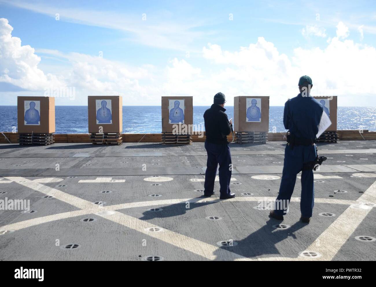 PACIFIC OCEAN (June 21, 2017) Civilian Mariners conduct live fire arms training onboard the flight deck of USNS Sacagawea (T-AKE 2) during Koa Moana 17, June 21. The Koa Moana 17 (Ocean Warrior) exercise is designed to improve interoperability; enhance military-to-military relations and expose Marine Corps forces to different types of terrain for familiarity in the event of a natural disaster or crisis in the region. ( Stock Photo
