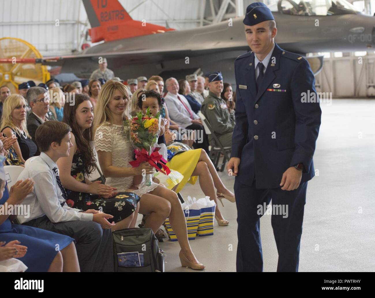 Carla Abba glances down at the bouquet of flowers from her husband, Col. David Abba, the new 53rd  Wing commander, during his change of command June 20 at EglinAir Force Base, Fla. The wing also welcomed their children. Nyah, Jack, Serena, Lauren and Lani. Stock Photo