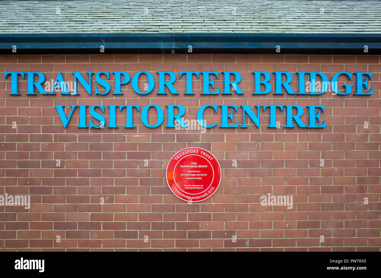 Middlesbrough Transporter Bridge Visitor Centre sign and a red Plaque for a Transport Heritage Site Stock Photo