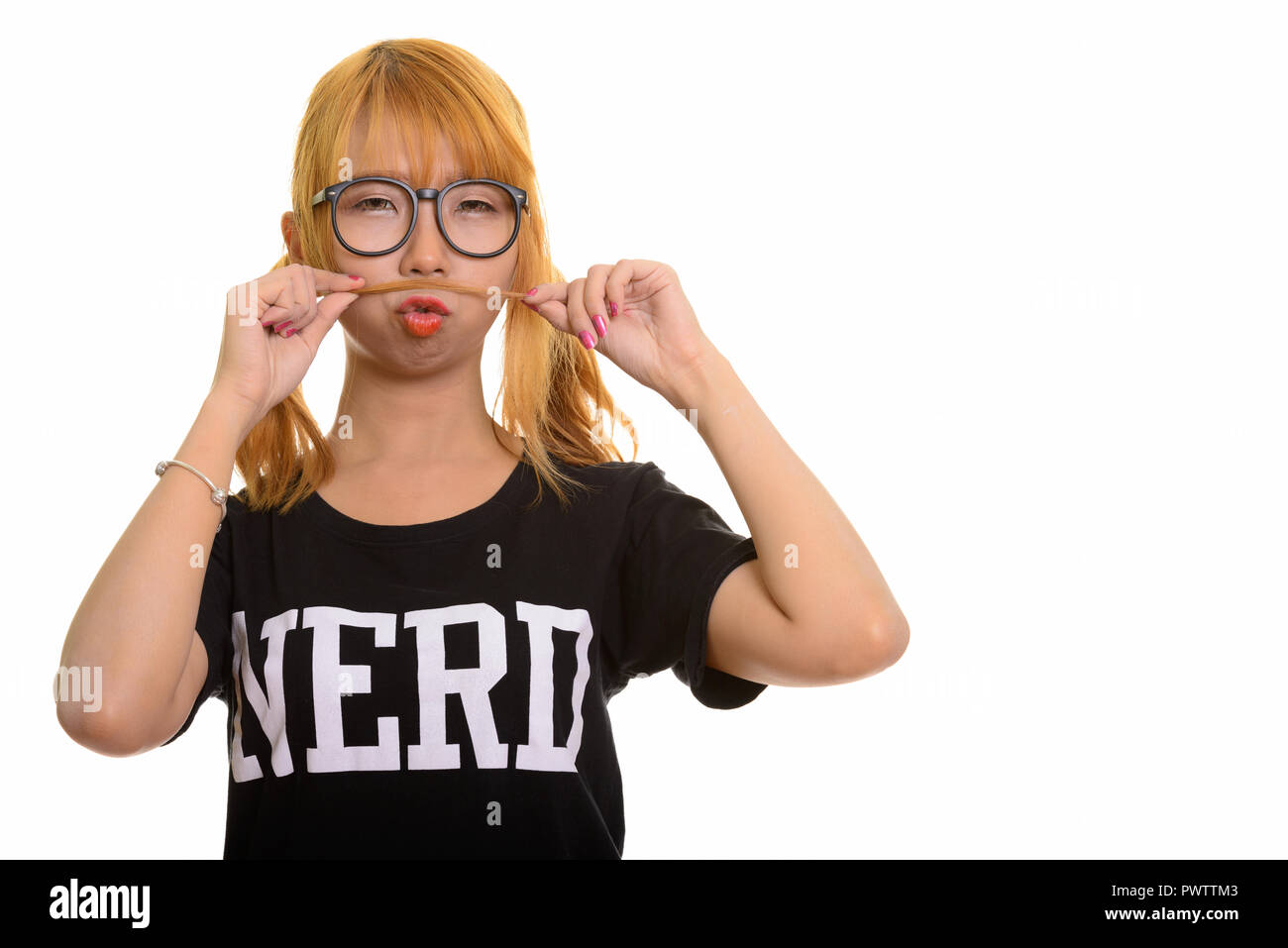 Young Asian nerd woman playing with her hair as moustache Stock Photo