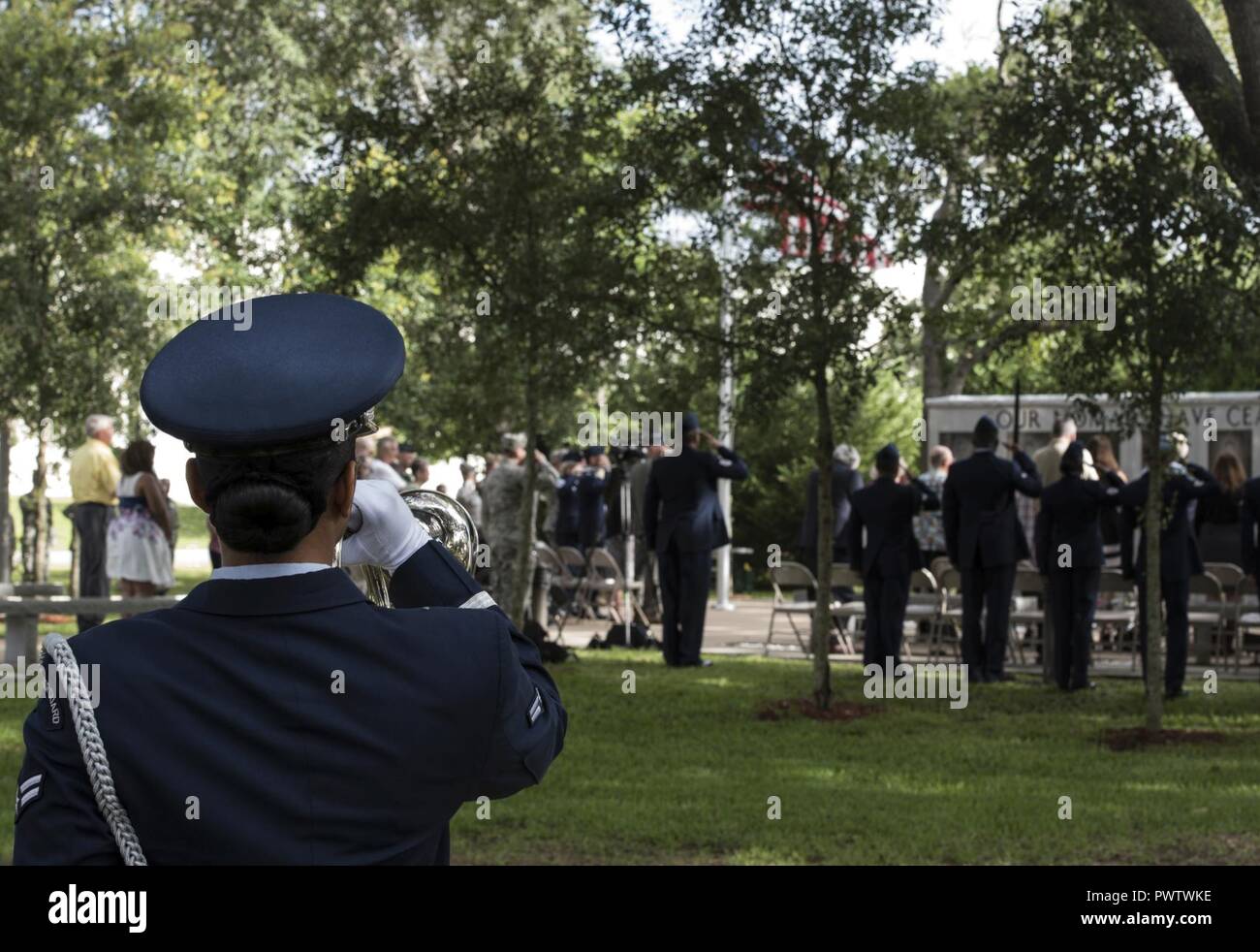 A member of the base Honor Guard plays Taps during the Khobar Towers 21st Anniversary Wreath Laying Ceremony June 23, 2017, at Eglin Air Force Base, Florida. On June 25, 1996, a bomb was detonated near the Khobar Towers housing complex in Dhahran, Saudi Arabia. Nineteen Airmen were killed and more than 400 U.S. and international military and civilians were injured in the blast.  Of the 19 killed, 12 were Nomads. The Nomad Each year the 33 FW holds a ceremony in remembrance of that day. Stock Photo