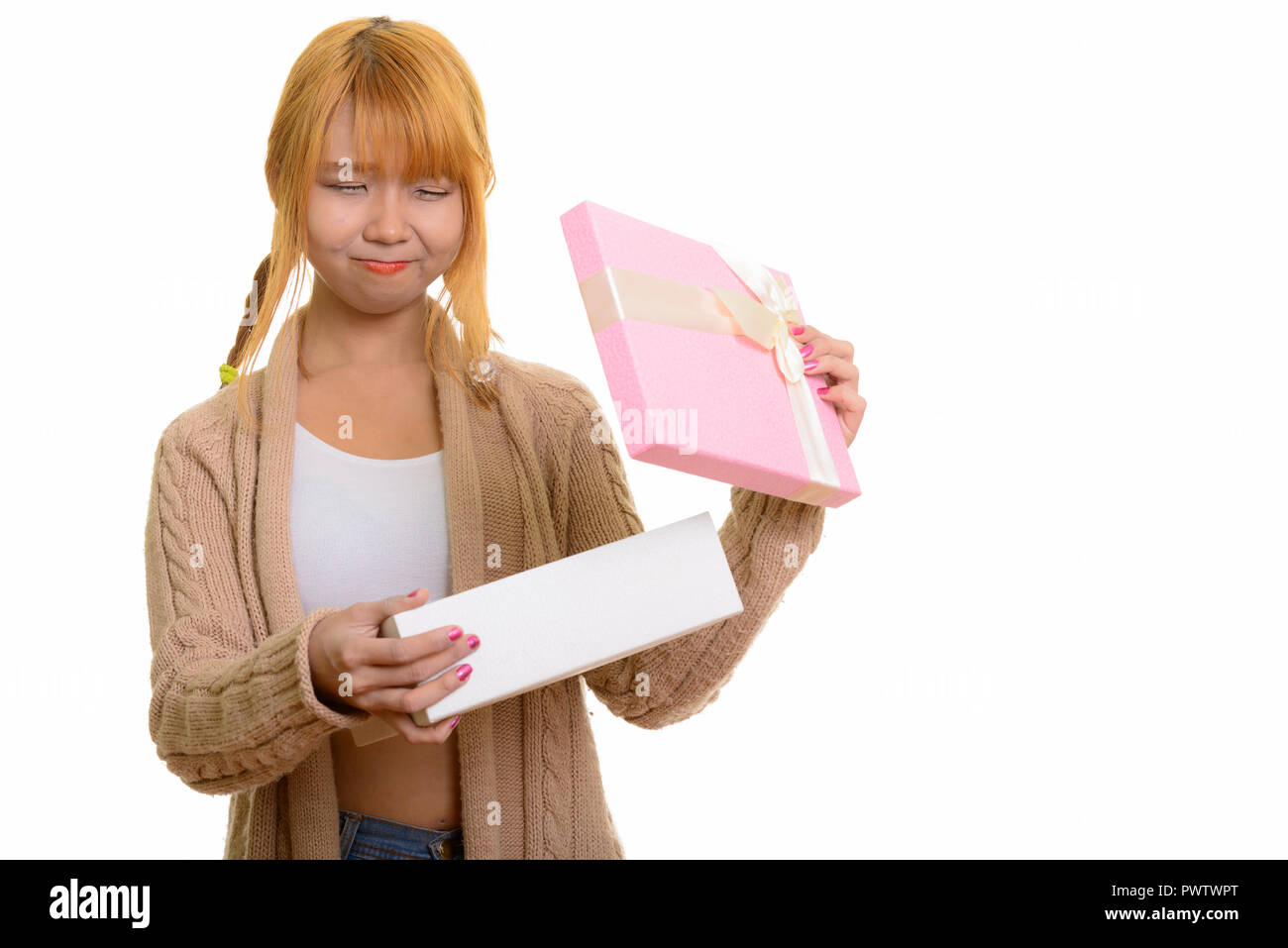 Young cute Asian woman opening gift box looking disappointed Stock Photo