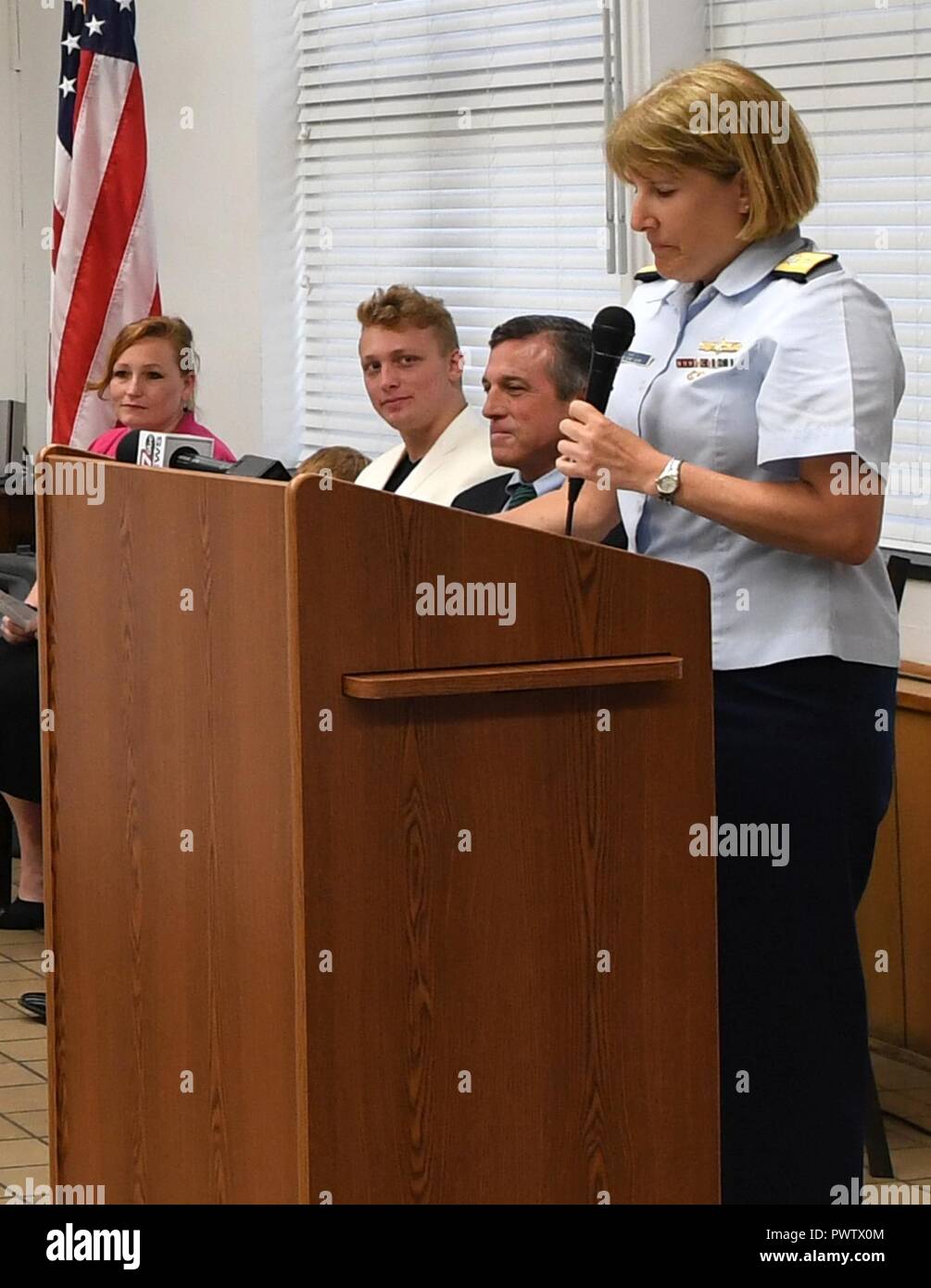 Rear Adm. Meredith Austin, commander, Coast Guard 5th District, describes the importance of the Silver Lifesaving Medal and its history during a posthumous Silver Lifesaving Medal ceremony at Coast Guard Station Indian River, Rehoboth Beach, Delaware, June 24, 2017.    The Silver Lifesaving Medal was awarded to the family of Michael Manley, who lost his life while rescuing his stepson from a rip current, Sept. 26, 2015.    Coast Guard Stock Photo