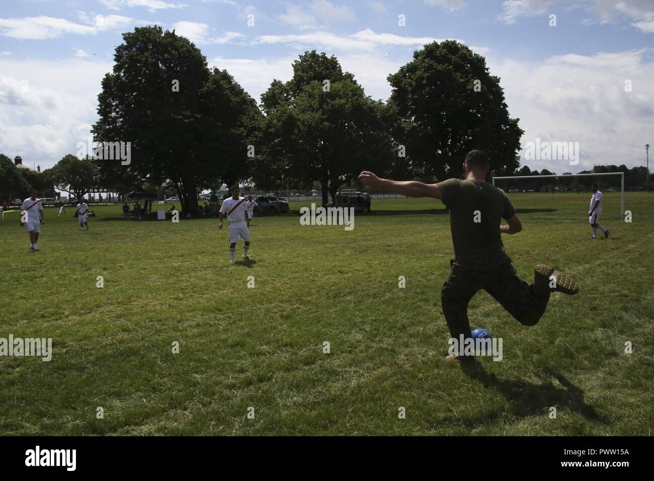 Lance Cpl. Scott Harder winds up to kick the ball to his teammates during the Sail Boston 2017 Soccer Tournament held at Joe Moakley Park in Boston, Mass., June 20, 2017. The tournament was a friendly competition aimed at establishing rapport among service members from around the world and others participating in Sail Boston. Marines and Sailors from countries including Chile, Peru, and Ecuador attended the tournament. Harder is a motor transport specialist assigned to Combat Logistics Battalion 8, Combat Logistics Regiment 2, 2nd Marine Logistics Battalion. Stock Photo