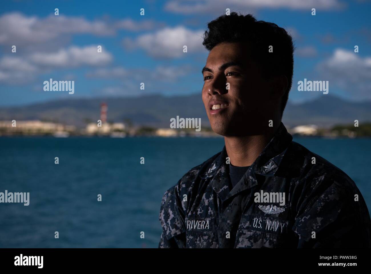 PEARL HARBOR (June 27, 2017) - Faces of the Deep: 'I graduated from high school with a desire to do something different and a goal to attend college,' said Machinist’s Mate (Nuclear) 2nd Class (SS) Romero Rivera, native of San Jose, California and Sailor aboard the Virginia-class submarine USS Mississippi (SSN 782). 'As a Sailor, I want to use the work experience to develop transferable skills so I can take them with me to college.'    'The Navy has taught me a lot about resilience, staying motivated and positively dealing with stress in the work place. There’s a lot of camaraderie on a submar Stock Photo