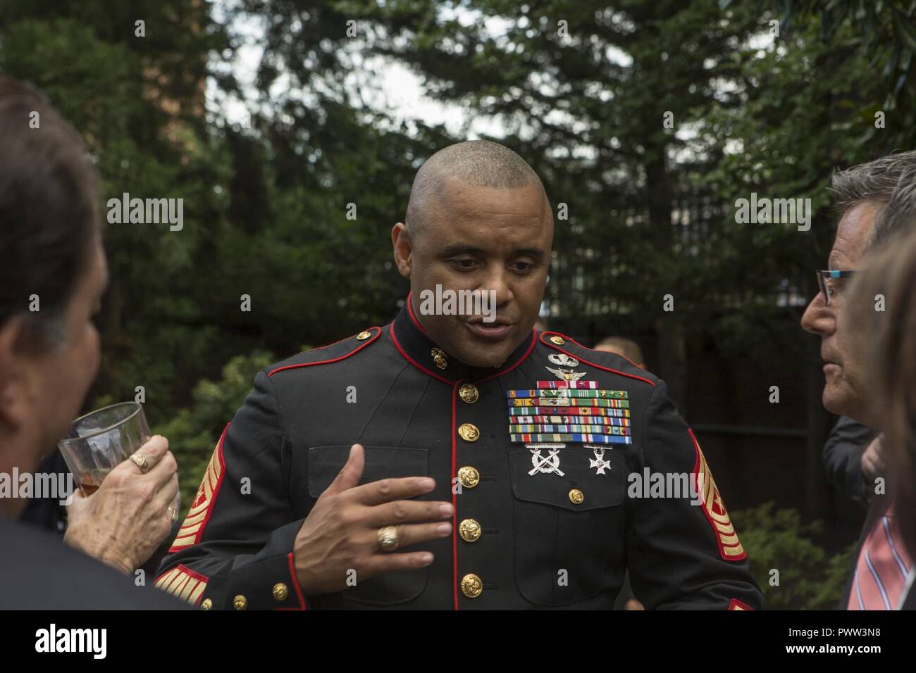 U.S. Marine Corps Sgt. Maj. Edward D. Parsons, sergeant major of Headquarters and Service Battalion, speaks with guests during a reception before an evening parade at Marine Barracks Washington, Washington D.C. June 23, 2017. Evening parades are held as a means of honoring senior officials distinguished citizens and supporters of the Marine Corps. Stock Photo