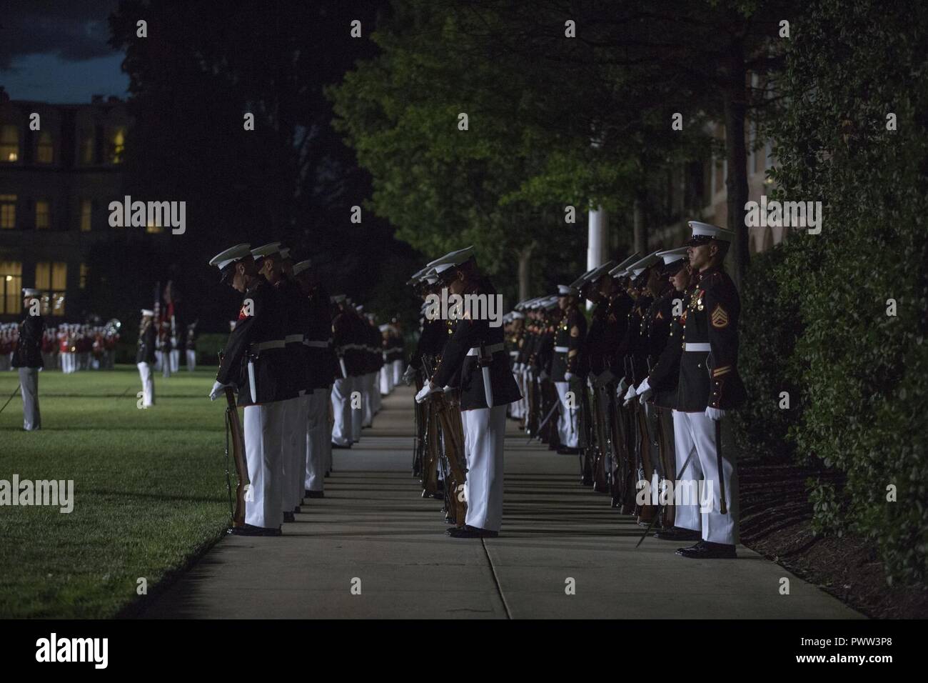U.S. Marines with Marine Barracks Washington perform during an evening parade, Marine Barracks Washington, Washington, D.C., June 23, 2017. Evening parades are held as a means of honoring senior officials, distinguished citizens and supporters of the Marine Corps. Stock Photo