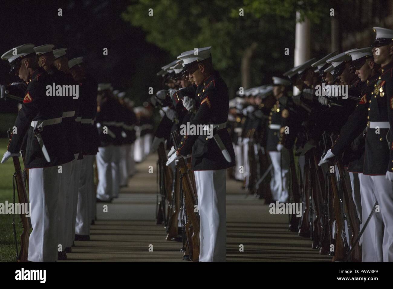 U.S. Marines with Marine Barracks Washington perform during an evening parade, Marine Barracks Washington, Washington, D.C., June 23, 2017. Evening parades are held as a means of honoring senior officials, distinguished citizens and supporters of the Marine Corps. Stock Photo