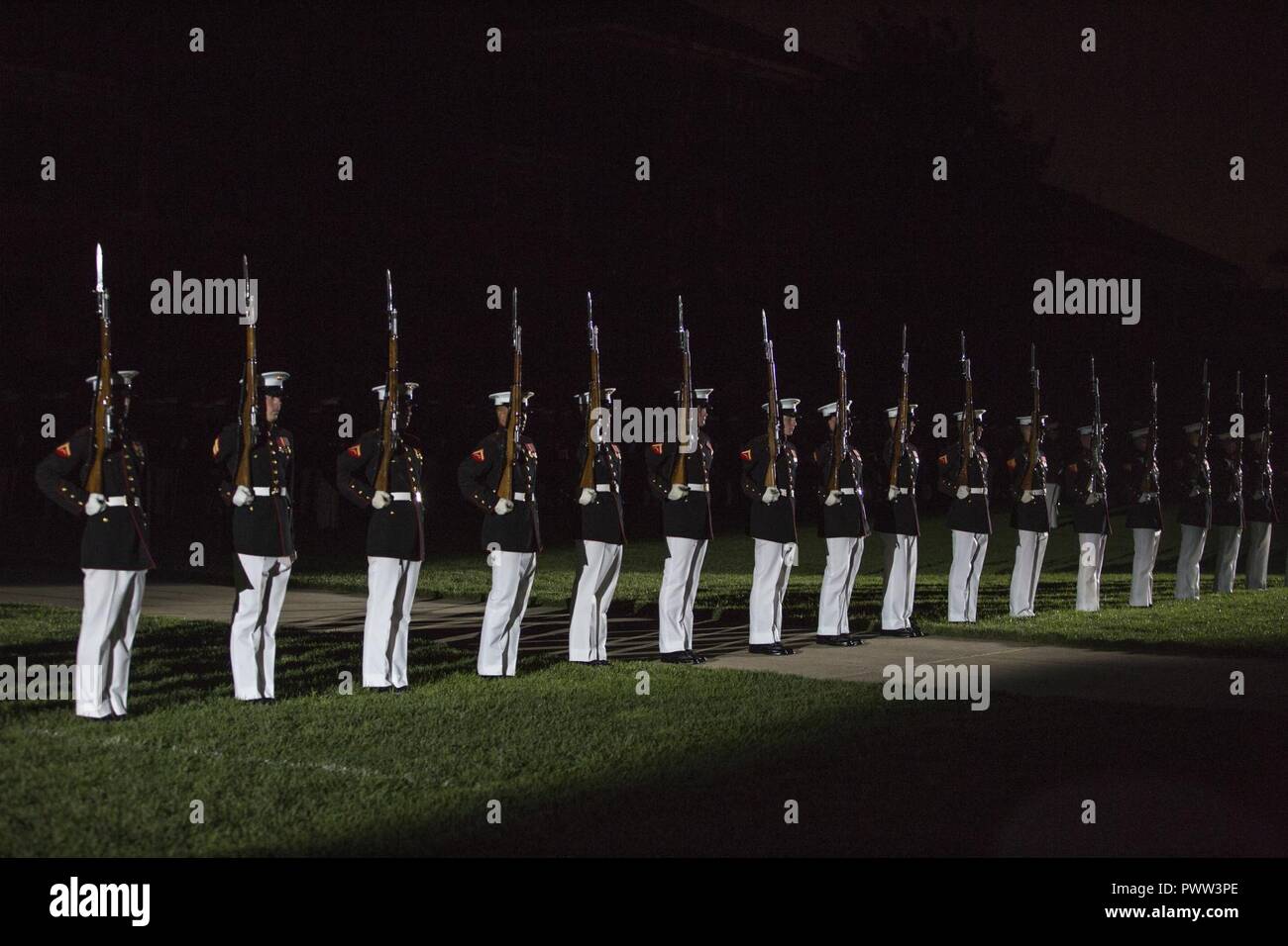 The Marine Corps Silent Drill Platoon performs during an evening parade at Marine Barracks Washington, Washington, D.C., June 23, 2017. Evening parades are held as a means of honoring senior officials, distinguished citizens and supporters of the Marine Corps. Stock Photo