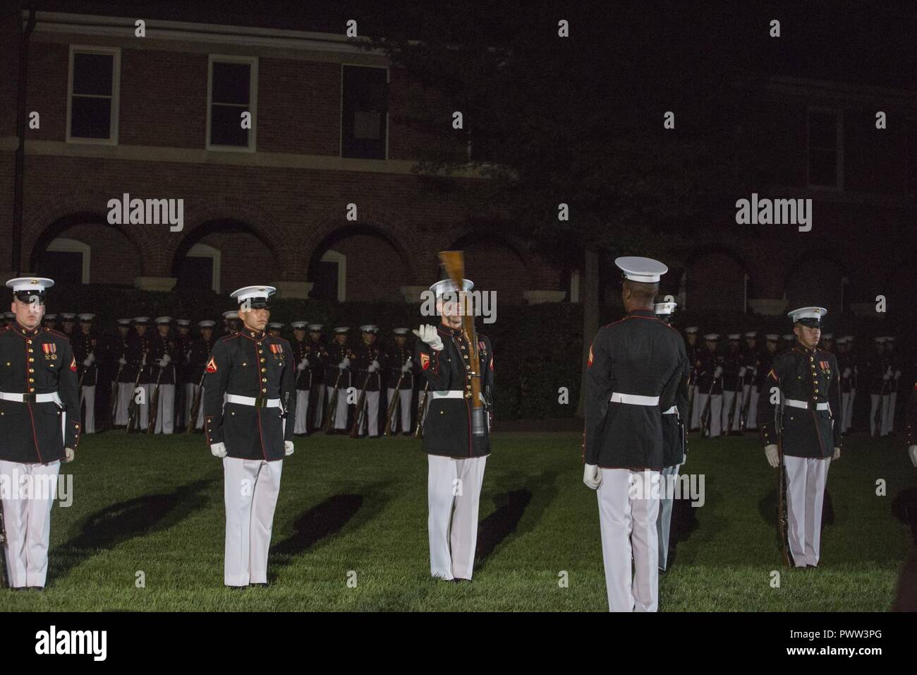 The Marine Corps Silent Drill Platoon performs during an evening parade at Marine Barracks Washington, Washington, D.C., June 23, 2017. Evening parades are held as a means of honoring senior officials, distinguished citizens and supporters of the Marine Corps. Stock Photo