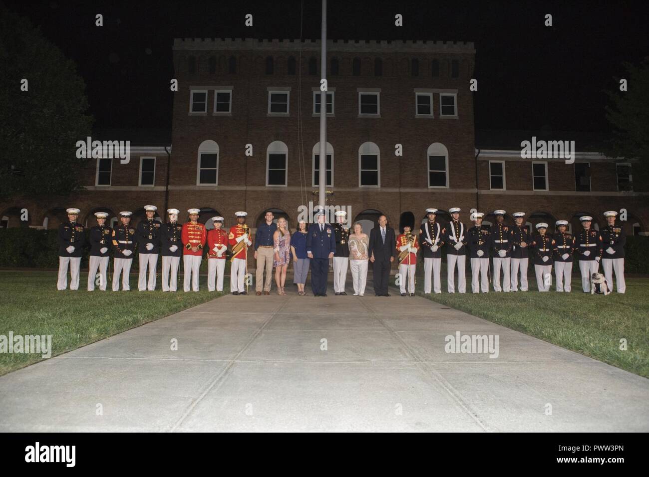 U.S. Air Force Lt. Gen. Thomas J. Trask, vice commander of Headquarters U.S. Special Operations Command (SOCOM) and Director Marine Corps Staff Lt. Gen. James B. Laster, pose for a group photo with Marines and civilians during an evening parade at Marine Barracks Washington, Washington, D.C., June 23, 2017. Evening parades are held as a means of honoring senior officials, distinguished citizens and supporters of the Marine Corps. Stock Photo