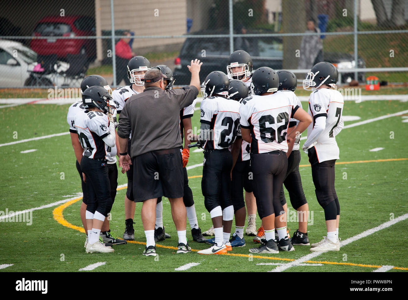 Coach talking to and instructing White Bear High School football team during game time out. St Paul Minnesota MN USA Stock Photo