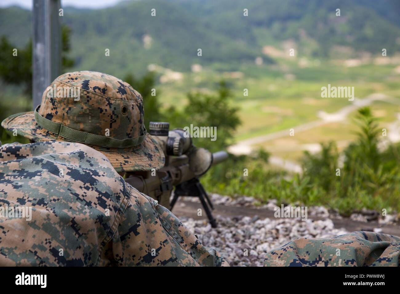 U.S. Marine Sgt. Cody L. Stacks, a Scout Sniper assigned to Weapons Company, 3rd battalion, 8th Marine Regiment, forward deployed to the 3rd Marine Division, as part of the forward Unit Deployment Program, Shoots the M110 Semi-Automatic Sniper System (M-110 SASS) at Rodriguez Live Fire Complex, South Korea, June 27, 2017. The M110 Is a 7.62mm, semi-automatic long range rifle used by the U.S. Military. Stock Photo