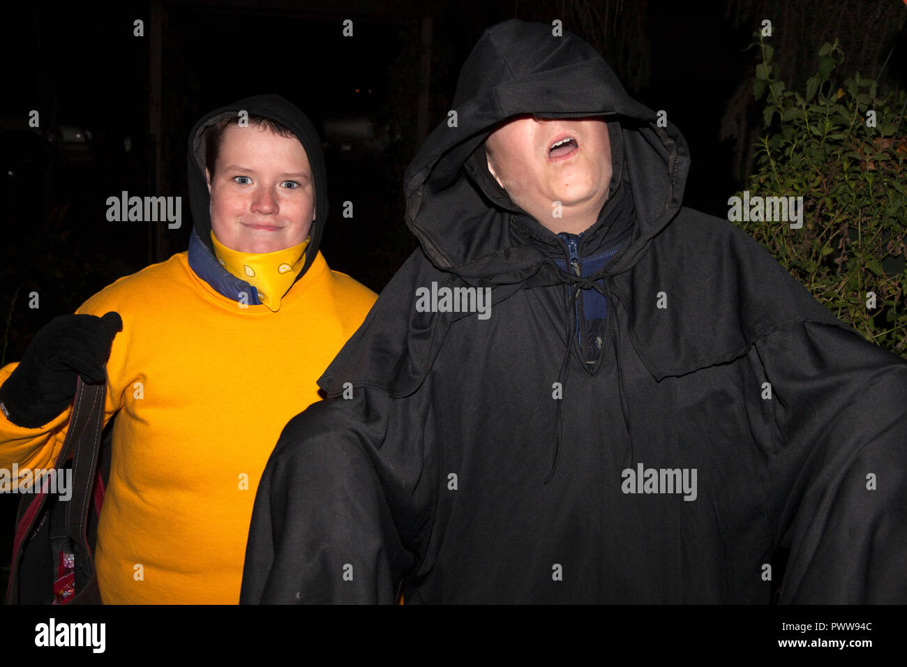 Masked trick or treaters with a red Roblox prime gaming shirt and a  Halloween ghoul in costume. St Paul Minnesota MN USA Stock Photo - Alamy