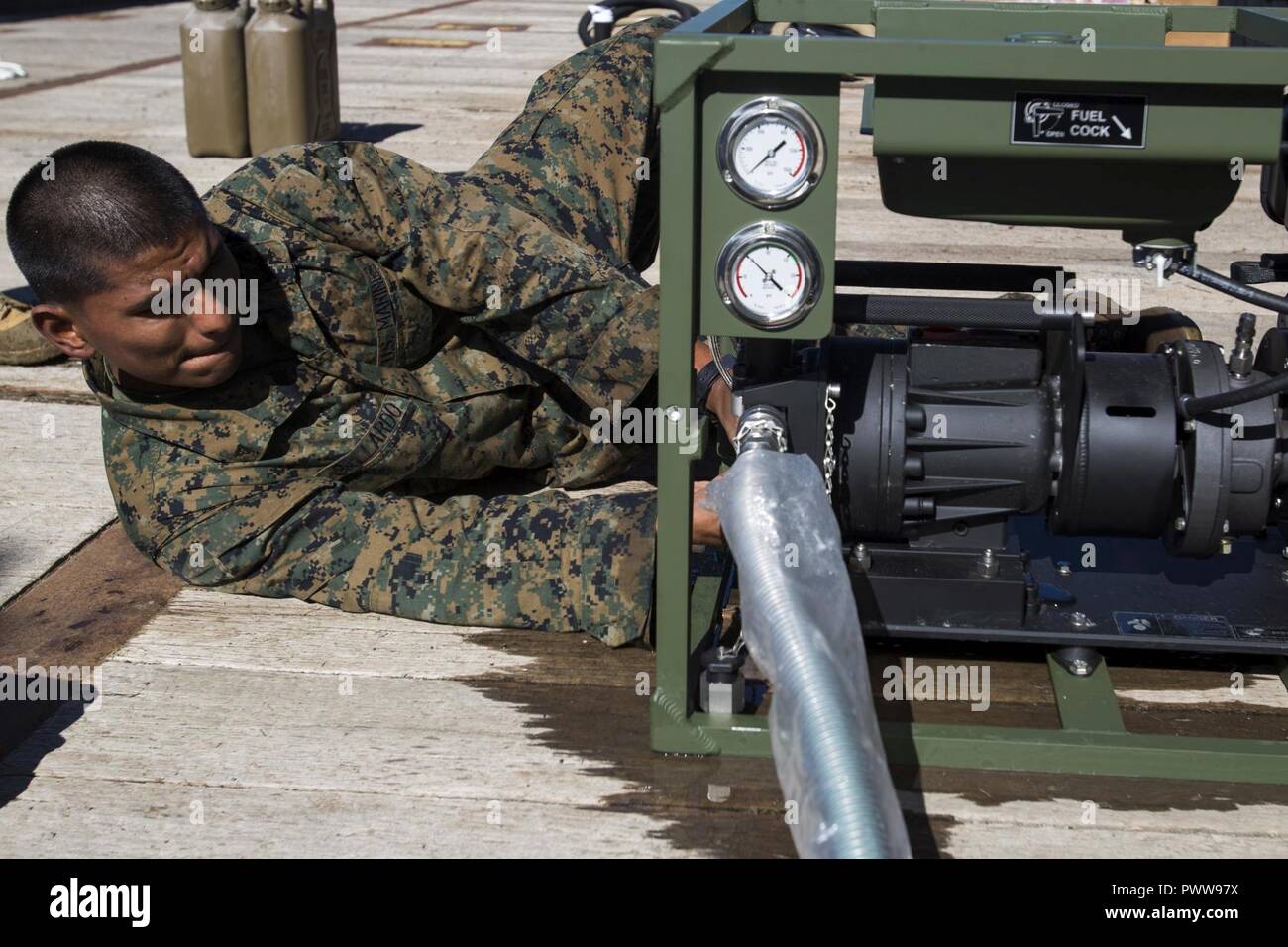 USNS SACAGAWEA— Lance Cpl. Ivan Gallardo performs an operation check on