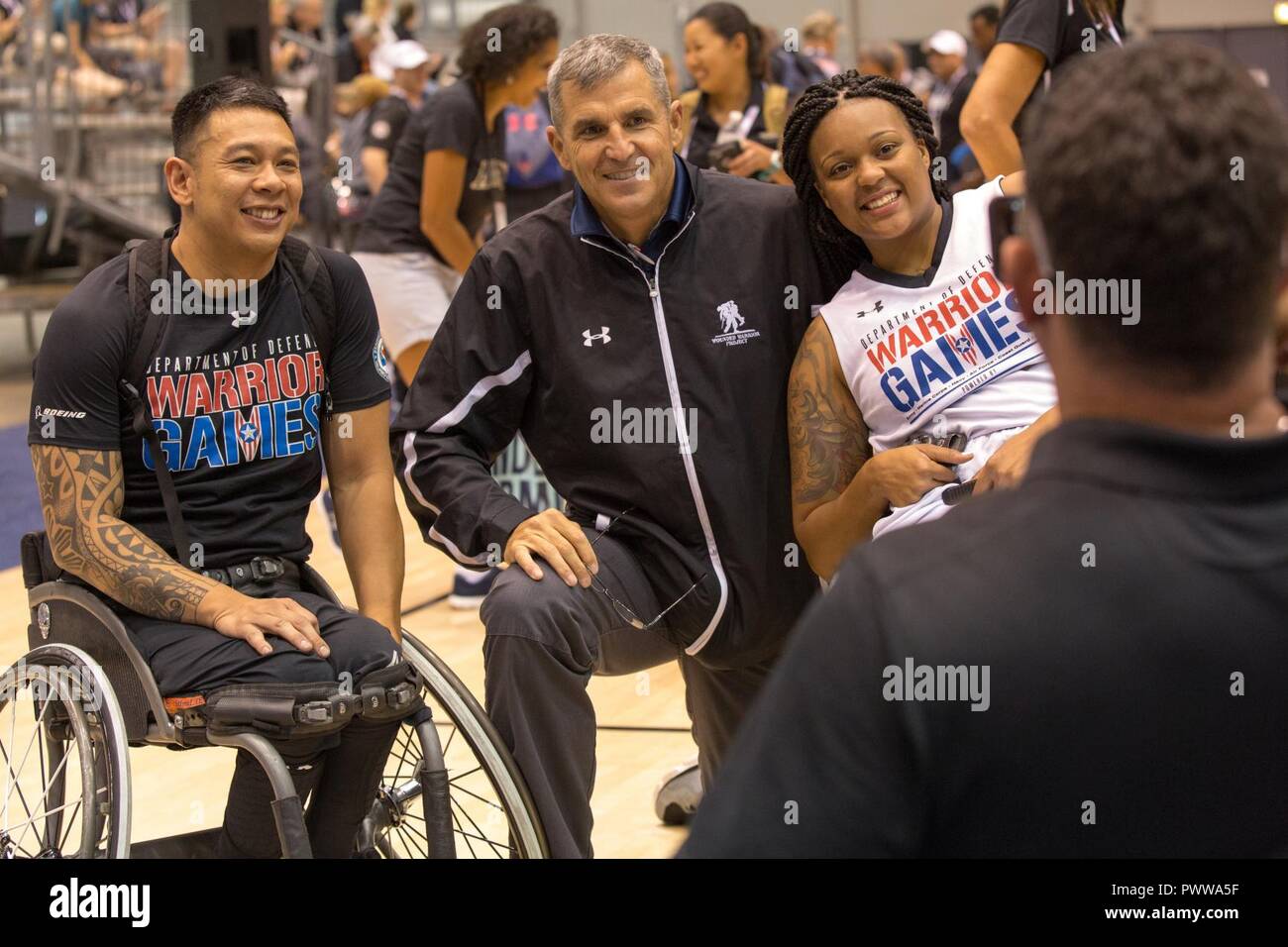 U.S. Army veteran Jhoonar Barrera, Chief executive officer Mike Linnington  of Wounded Warrior Project and U.S. Army Spc. Stephanie Morris, posses for  a photo after the wheelchair basketball competition for the 2017