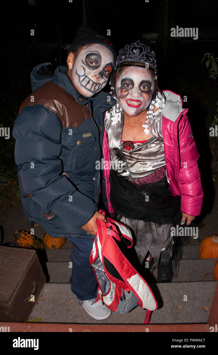 Mexican American couple costumed for 'Day of the Dead' 'Dia de Los Muertos' out for a night of Halloween tricks or treats. St Paul Minnesota MN USA Stock Photo